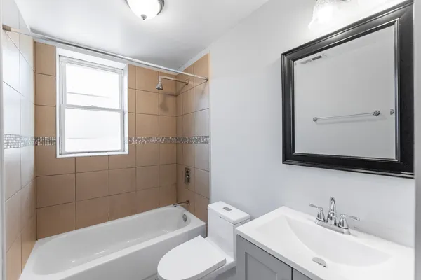 a bathroom with a toilet a sink and bathtub
