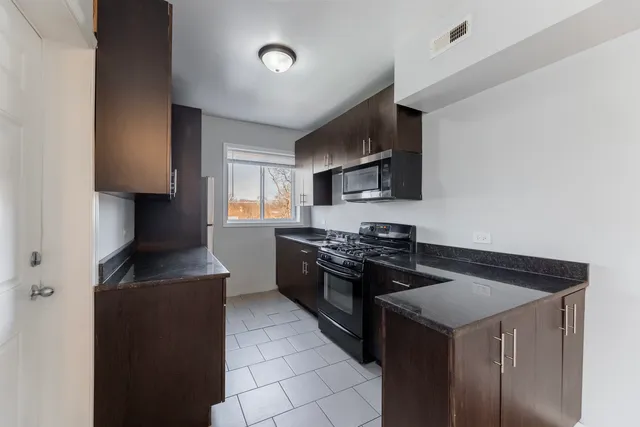 a kitchen with a stove and a refrigerator
