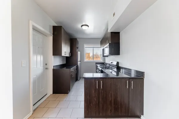 a kitchen with stainless steel appliances a sink stove and refrigerator