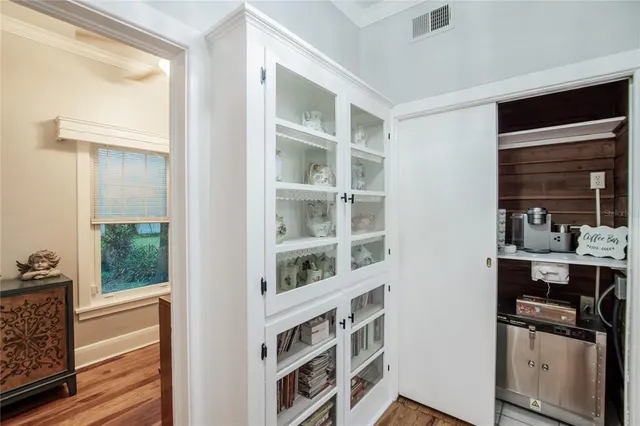 a bedroom with a bed and a flat tv screen on dresser