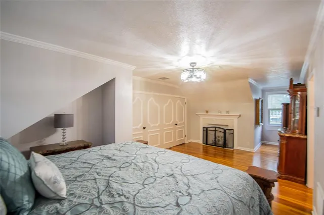 a spacious bedroom with a large bed and a chandelier