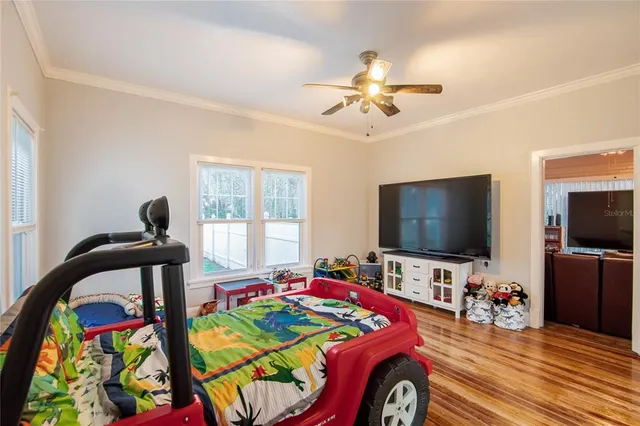 a spacious bedroom with a large bed and a chandelier
