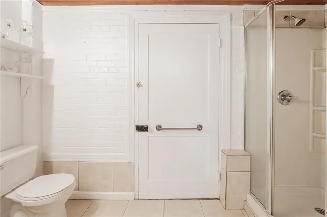 an aerial view of house with yard and mountain view in back