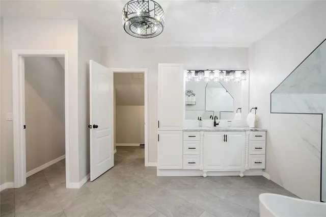 an aerial view of residential house with outdoor space and trees all around