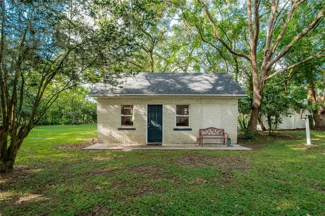 a front view of house with yard and outdoor seating