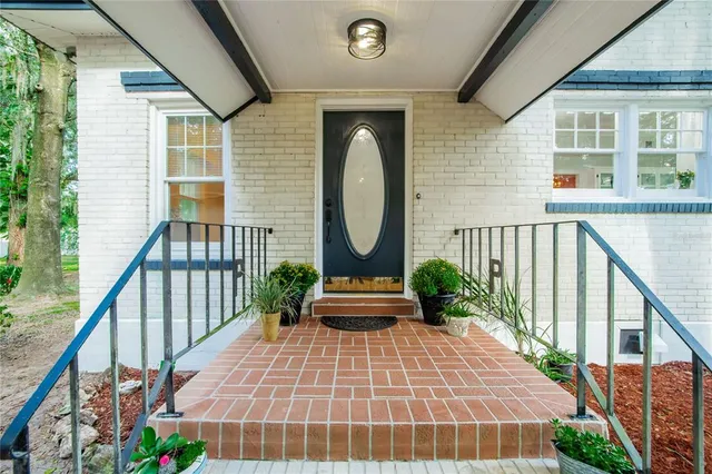 a front view of a house with a garden