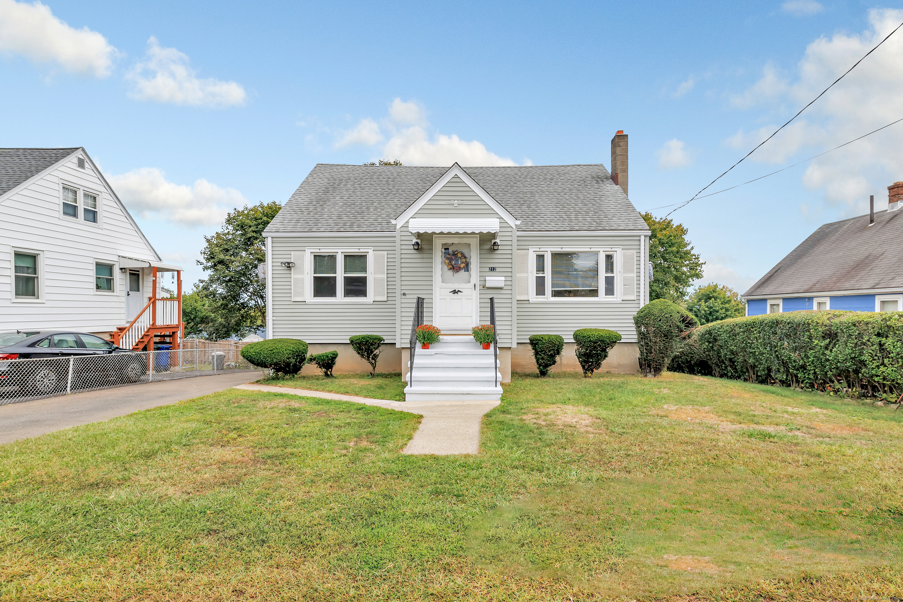 a front view of house with yard and green space