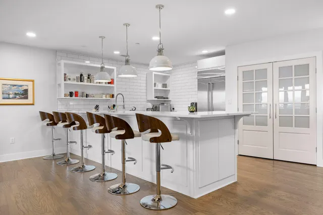 a living room with furniture and a view of kitchen