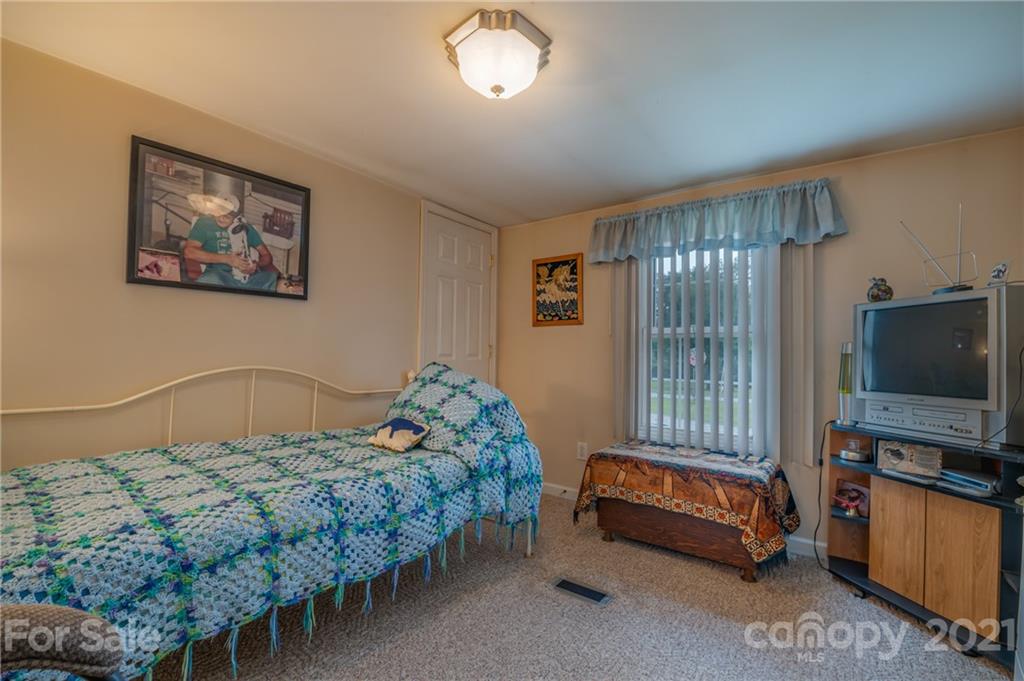 400 Howard Cole Road Rutherfordton, NC 28139 - Photo 15 of 29 a bedroom with a bed and a flat screen tv