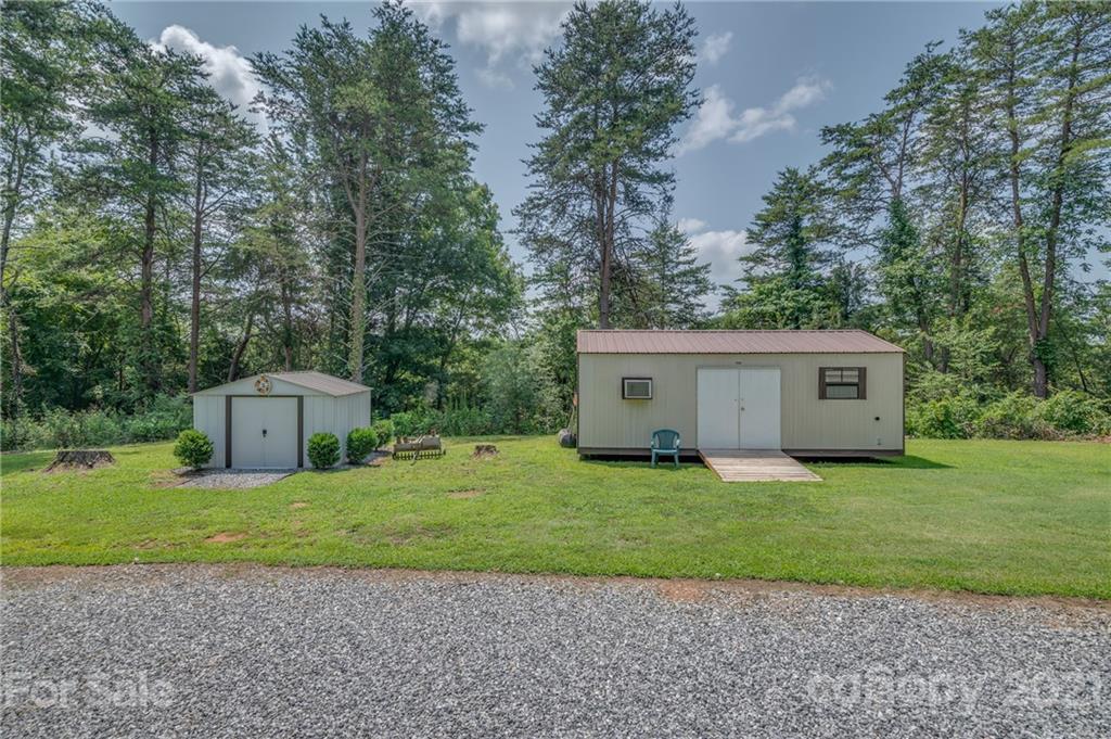 400 Howard Cole Road Rutherfordton, NC 28139 - Photo 22 of 29 a house with a big yard and a large trees with wooden fence