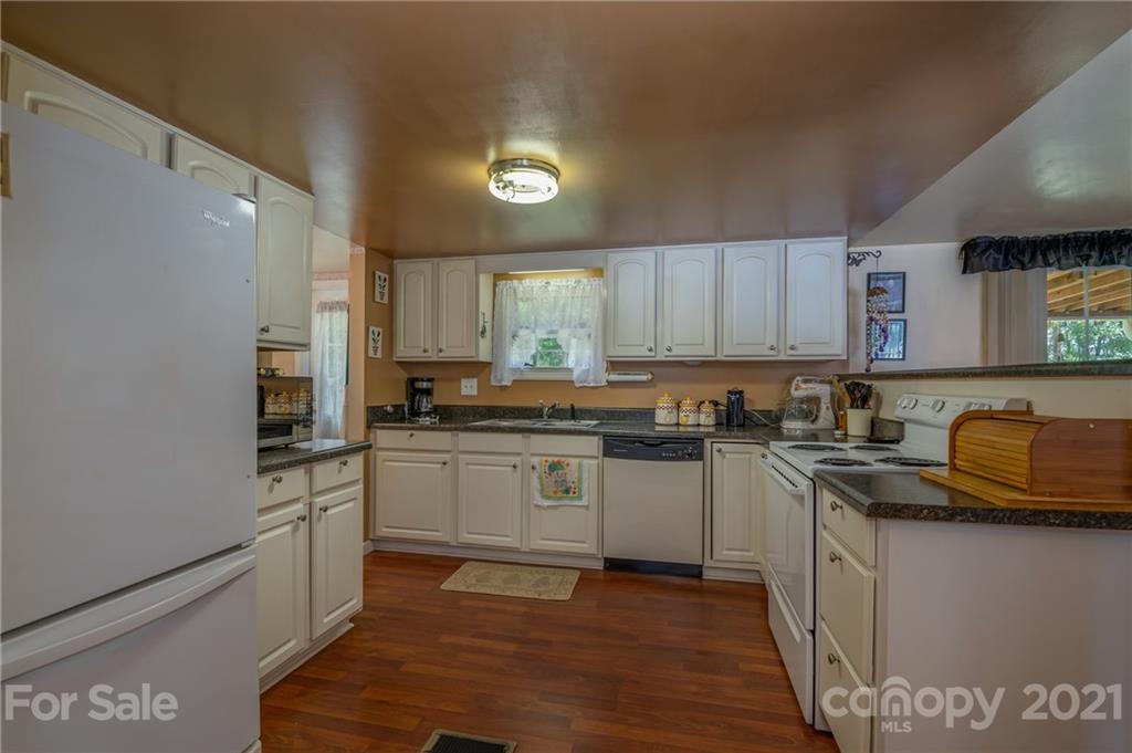 400 Howard Cole Road Rutherfordton, NC 28139 - Photo 6 of 29 a kitchen with stainless steel appliances granite countertop a stove a sink and a refrigerator