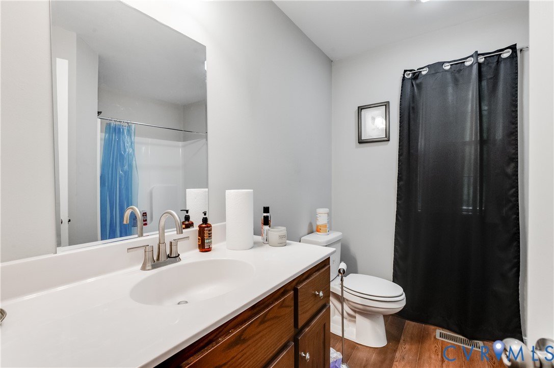 24580 St James Road Jetersville, VA 23083 - Photo 4 of 25 Bathroom featuring a wood-finish vanity with a whi