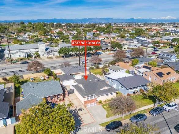 an aerial view of residential houses with yard
