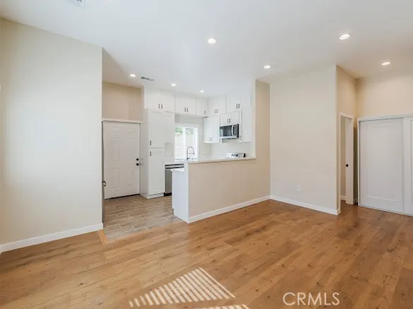 a view of kitchen with refrigerator and window