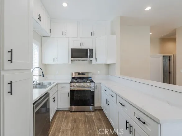 a kitchen with a sink a stove and microwave