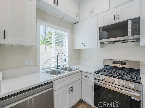a view of a big room with wooden floor and windows