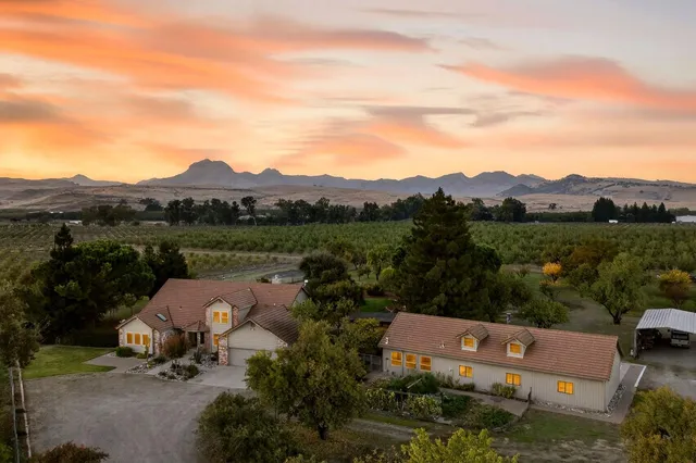 an aerial view of a house with mountain view
