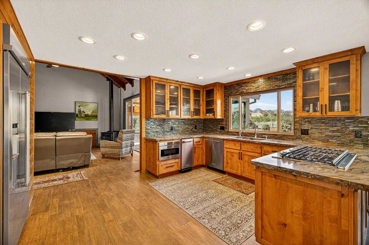 8617 South Butte Road Sutter, CA 95982 - Photo 15 of 64 a kitchen with stainless steel appliances granite countertop a stove a sink and a refrigerator
