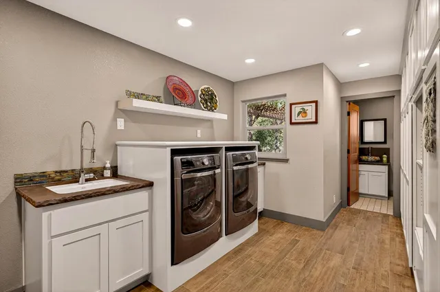 a view of a livingroom with wooden floor and a ceiling fan