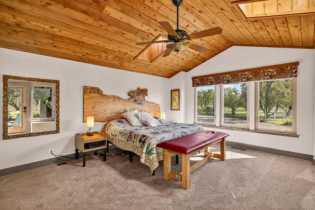 a view of a balcony with chairs and wooden fence