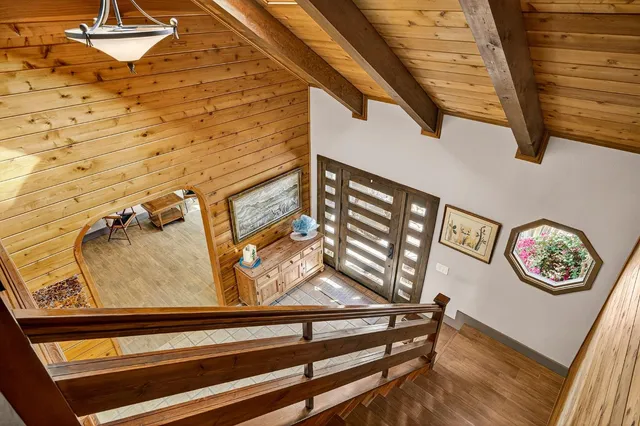 an aerial view of a house with a mountain in the background