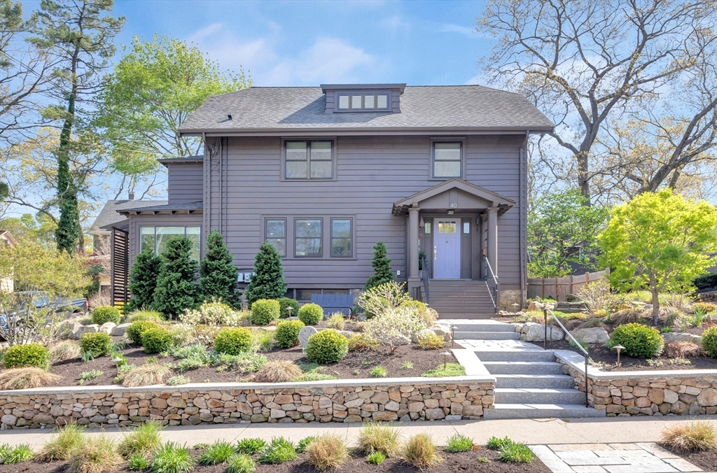 a front view of a house with garden