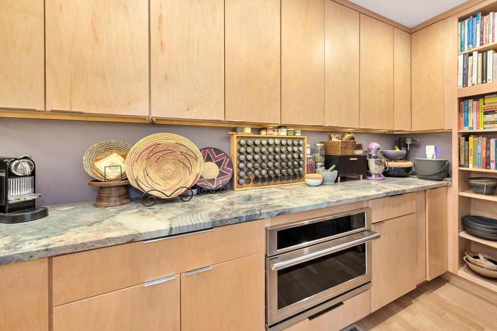 40 Holland Road Melrose, MA 02176 - Photo 15 of 42 a kitchen with granite countertop a sink a stove and cabinets