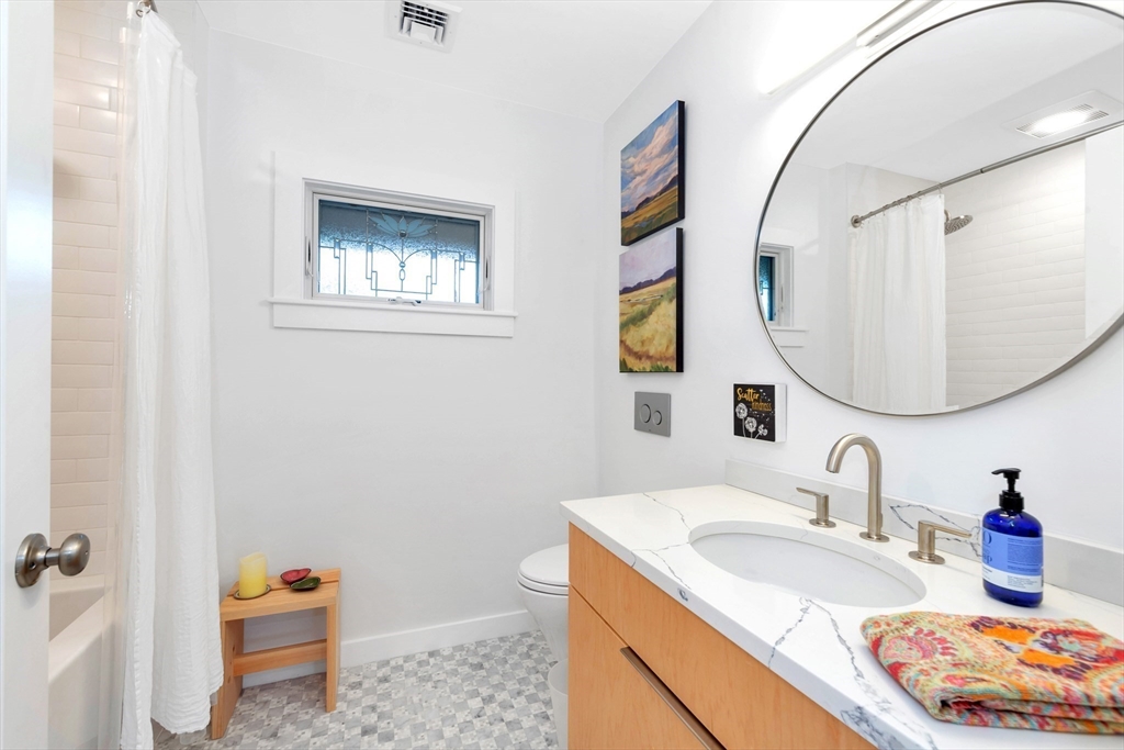 40 Holland Road Melrose, MA 02176 - Photo 25 of 42 a bathroom with a granite countertop sink and a mirror