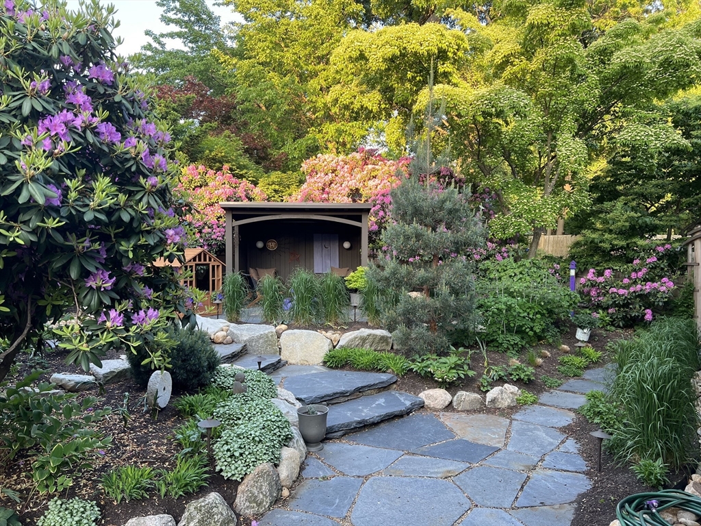 40 Holland Road Melrose, MA 02176 - Photo 32 of 42 a front view of a house with a yard and fountain