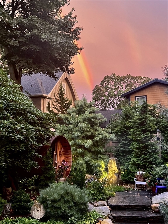 40 Holland Road Melrose, MA 02176 - Photo 33 of 42 a view of a backyard with plants and a houses