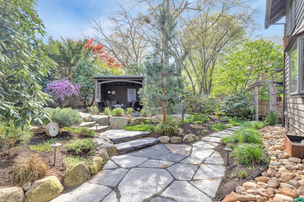 40 Holland Road Melrose, MA 02176 - Photo 36 of 42 a front view of a house with lots of plants and seating area