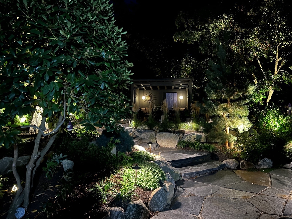 40 Holland Road Melrose, MA 02176 - Photo 40 of 42 a view of a backyard with plants and swing