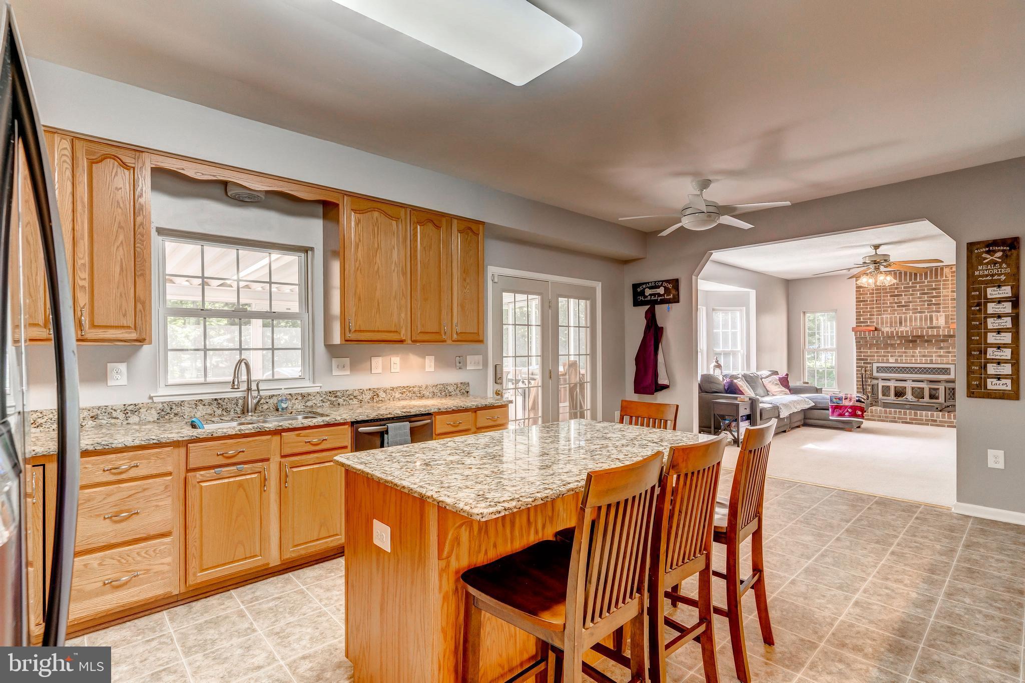 9855 Trinity Church Road Charlotte Hall, MD 20622 - Photo 3 of 77 Island with seating, heads out to screenedin deck