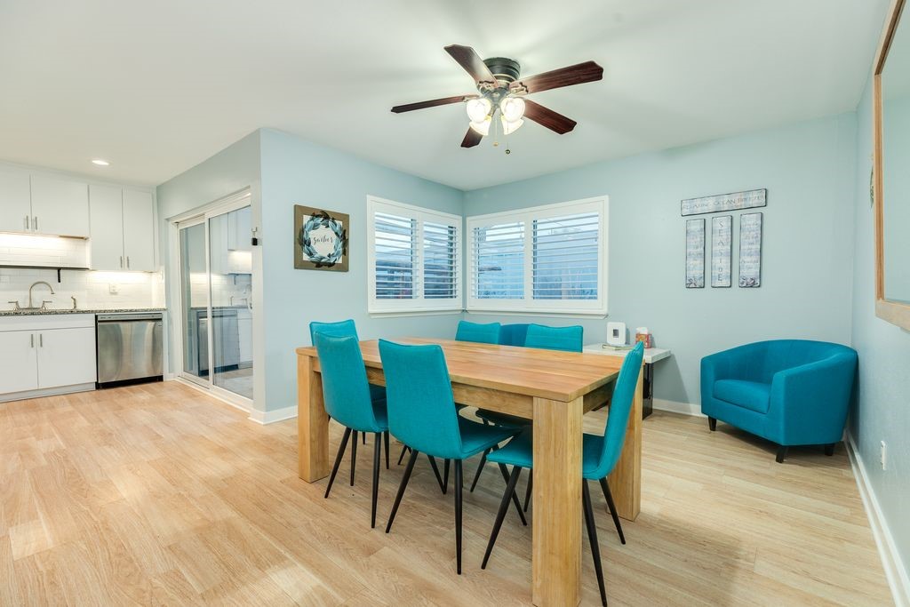 7516 Stewart Road Galveston, TX 77551 - Photo 11 of 25 a view of a dining room with furniture and a chandelier