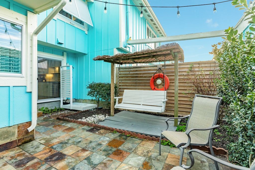 7516 Stewart Road Galveston, TX 77551 - Photo 14 of 25 a view of a chair and table in the patio