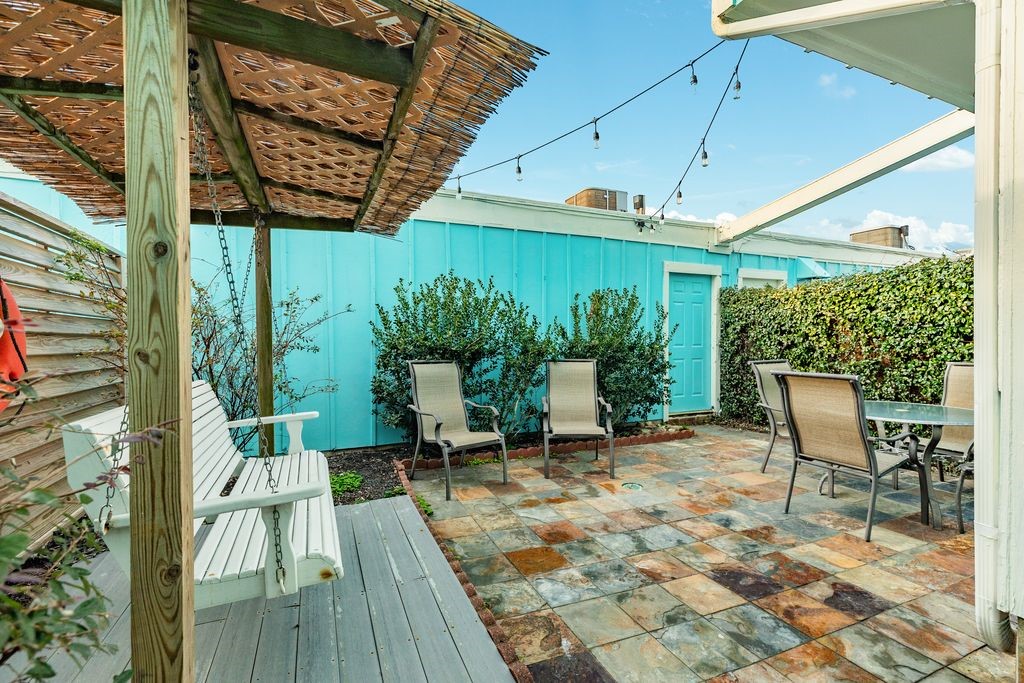 7516 Stewart Road Galveston, TX 77551 - Photo 15 of 25 a patio with glass windows and table