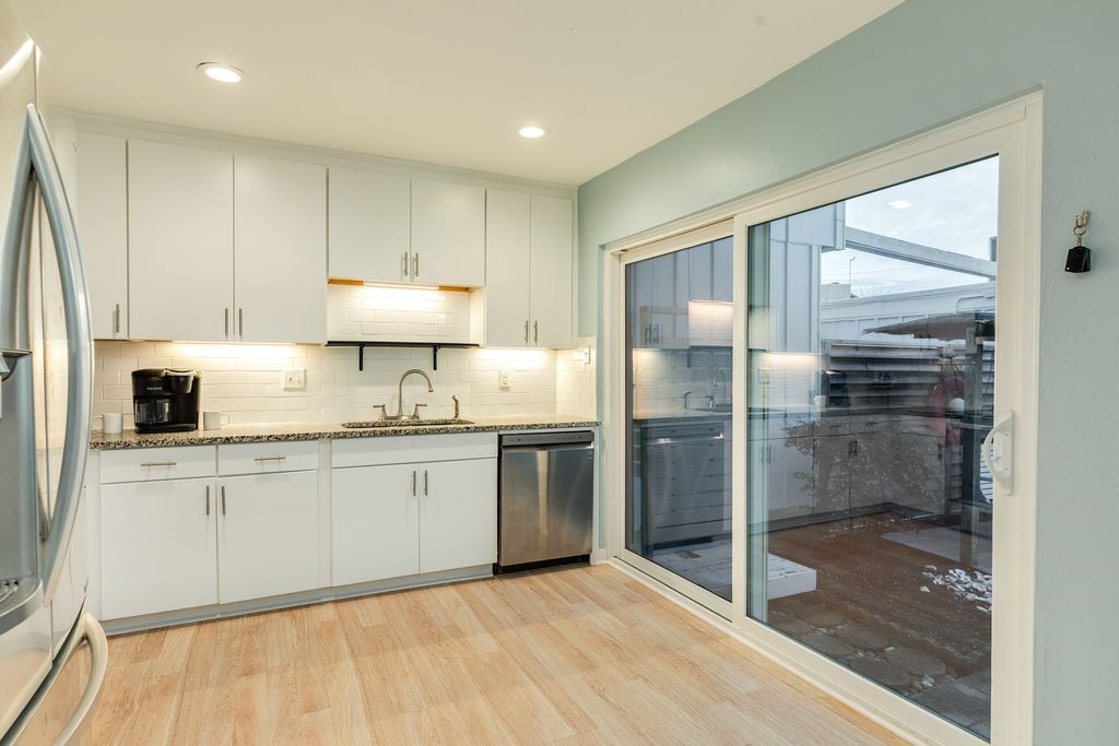 7516 Stewart Road Galveston, TX 77551 - Photo 10 of 25 a kitchen with stainless steel appliances granite countertop a refrigerator and a stove top oven