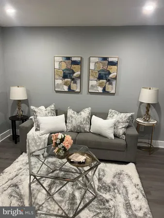 a living room with furniture and a lamp