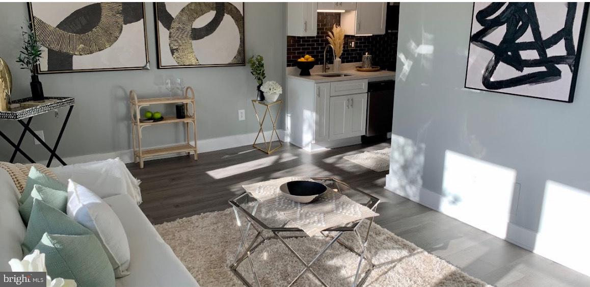 517 7th Street Northeast, Unit 2 Washington, DC 20002 - Photo 2 of 17 a living room with furniture and wooden floor