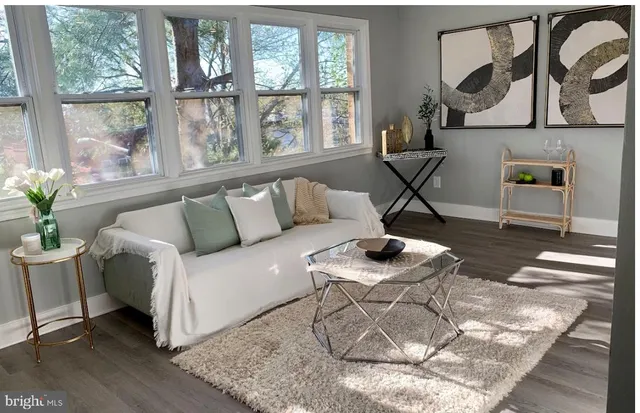 a living room with furniture and a floor to ceiling window