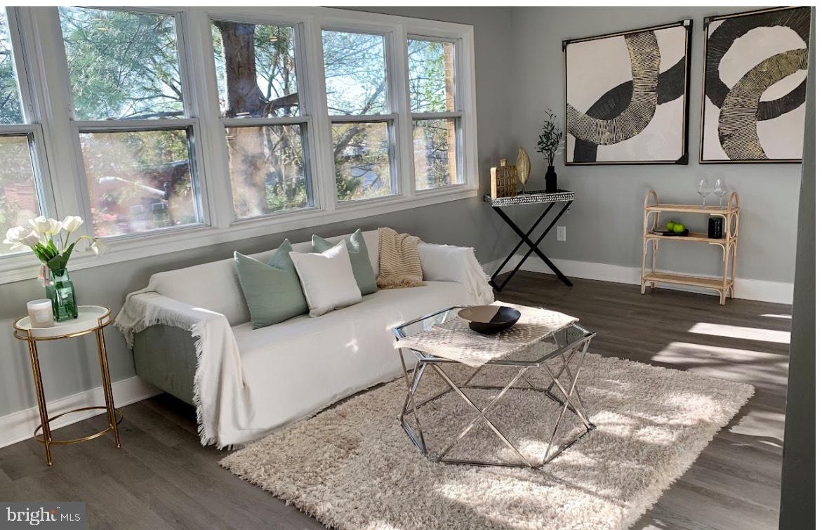 517 7th Street Northeast, Unit 2 Washington, DC 20002 - Photo 3 of 17 a living room with furniture and a floor to ceiling window