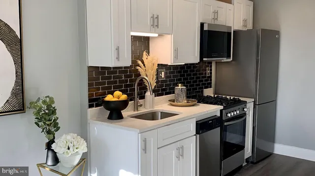 a kitchen with a sink and a stove top oven
