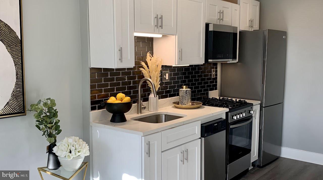 517 7th Street Northeast, Unit 2 Washington, DC 20002 - Photo 4 of 17 a kitchen with a sink and a stove top oven