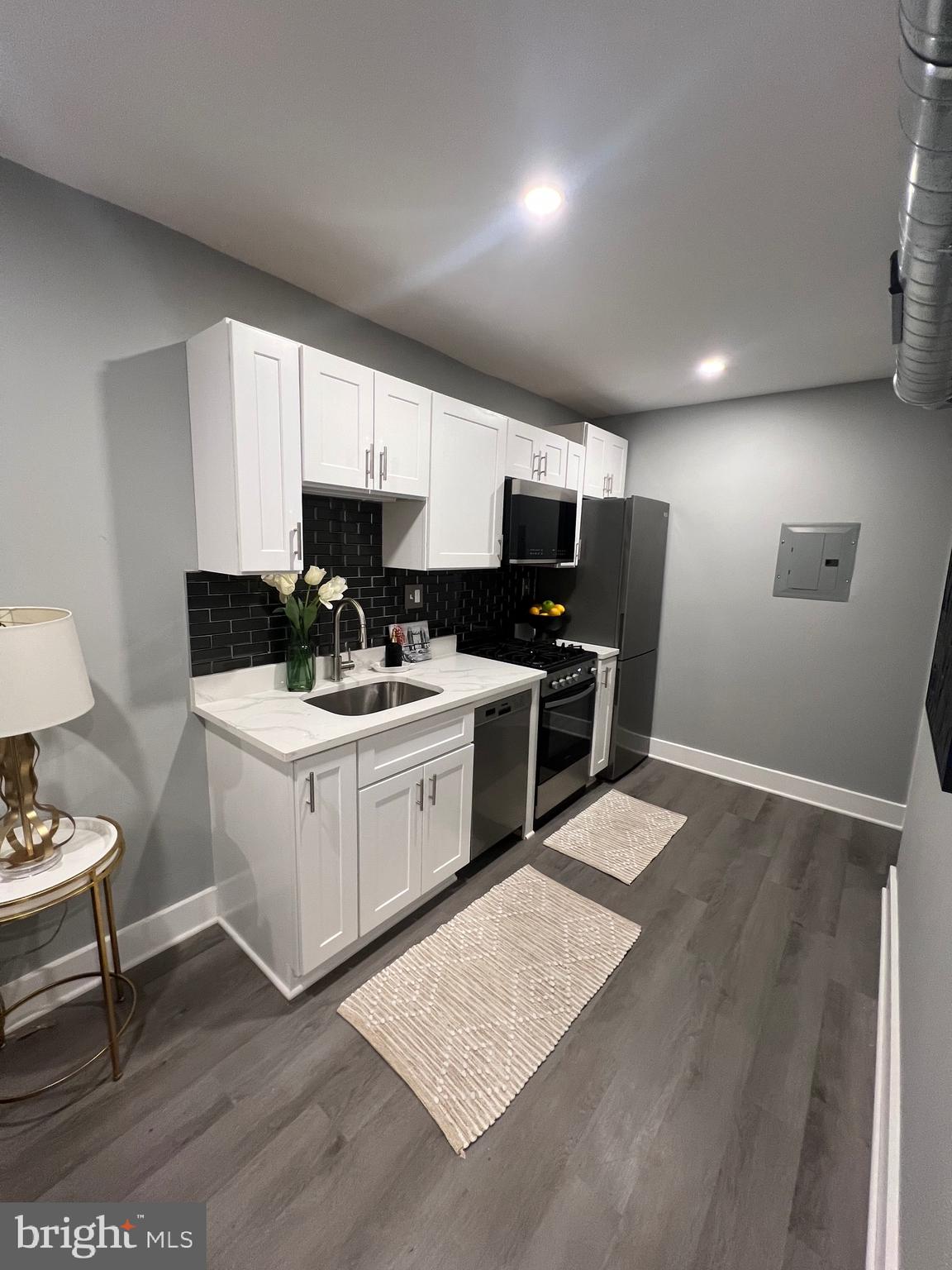 517 7th Street Northeast, Unit 2 Washington, DC 20002 - Photo 9 of 17 a kitchen with a sink cabinets and wooden floor