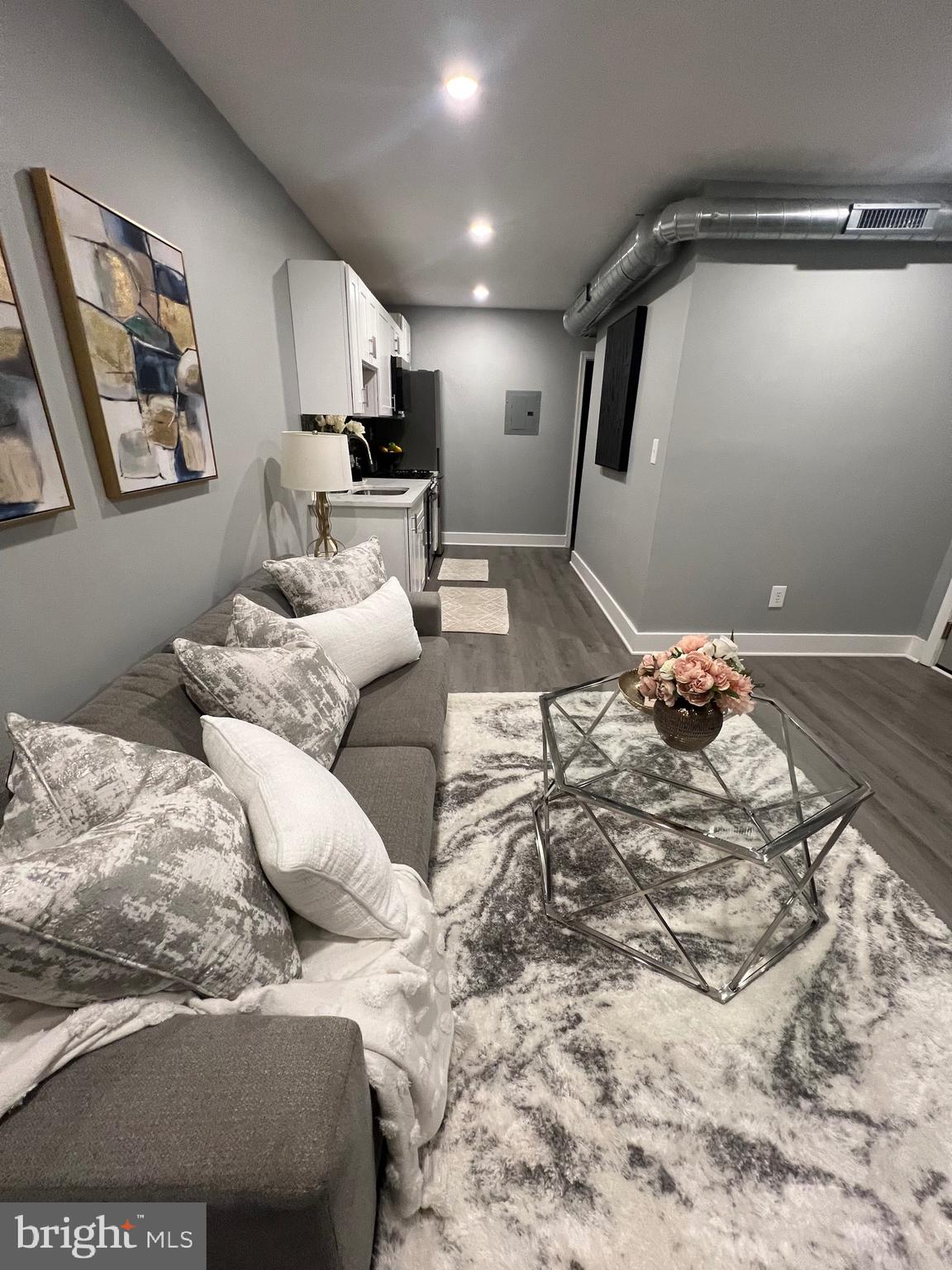 517 7th Street Northeast, Unit 2 Washington, DC 20002 - Photo 10 of 17 a bedroom with a large bed and a couch