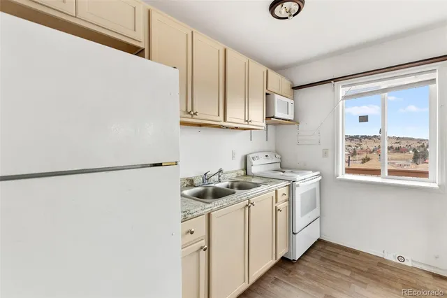 a kitchen with a sink a stove and cabinets