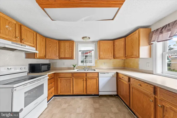 a kitchen with sink cabinets and refrigerator