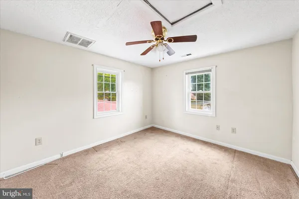 a bedroom with a bed couch and window