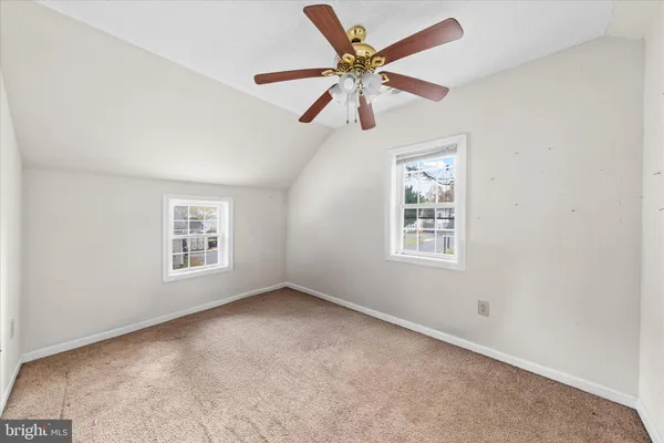 a bedroom with a bed couches and window