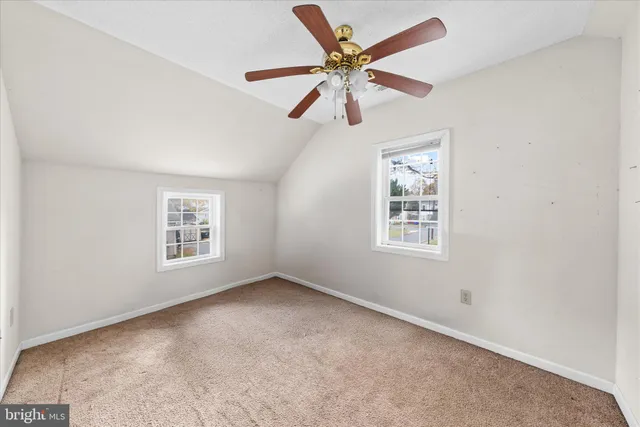 a bedroom with a bed couches and window